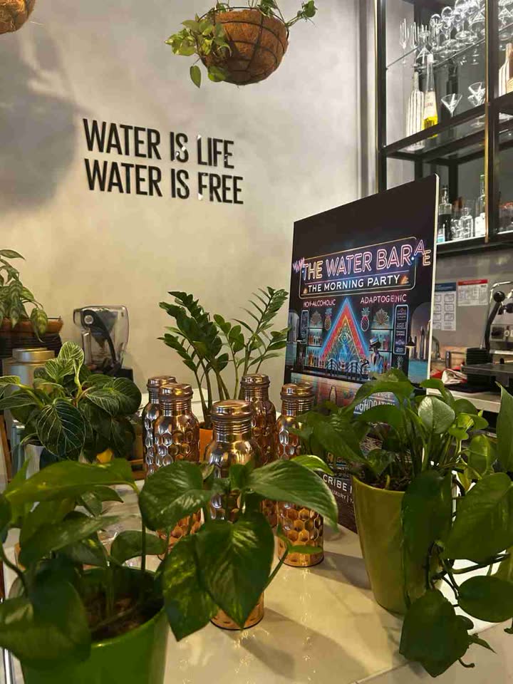 Copper bottles under a sign about water